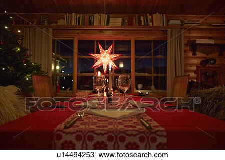 Table set for Christmas in log cabin at night View Large Photo Image Stock Image - Table set for Christmas in log cabin at night. Fotosearch