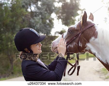 Teenage girl petting horse View Large Photo Image Picture - Teenage girl petting horse. Fotosearch