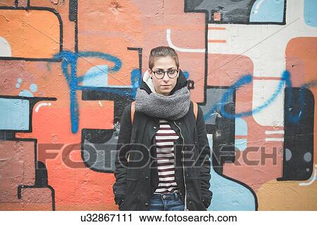 Stock Image - Teenager by graffiti wall. Fotosearch