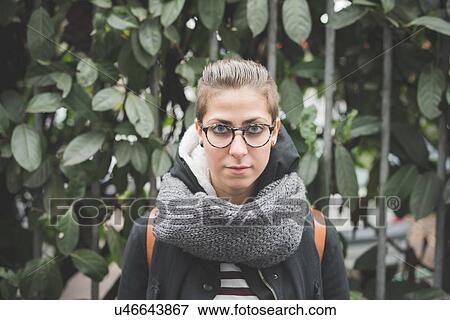 Stock Photo - Teenager by green plant. Fotosearch