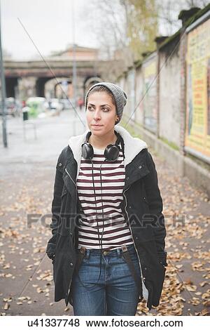 Stock Photo - Teenager with headphones on street. Fotosearch