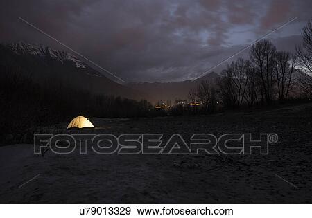 Stock Photo - "Tent illuminated at night, Premosello, Verbania, Piedmonte, Italy". Fotosearch