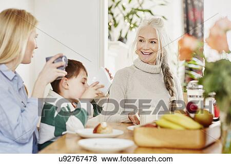 Three generation family having breakfast View Large Photo Image Stock Photo - Three generation family having breakfast. Fotosearch