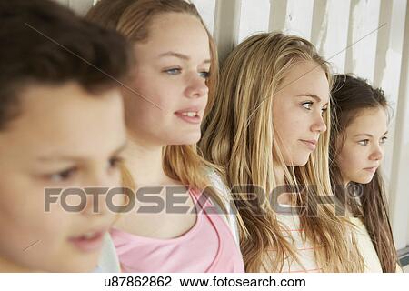 Three girls and boy looking out from shelter View Large Photo Image Stock Image - Three girls and boy looking out from shelter. Fotosearch