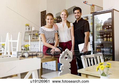 "Three people working in cafe, portrait" View Large Photo Image Stock Image - "Three people working in cafe, portrait". Fotosearch