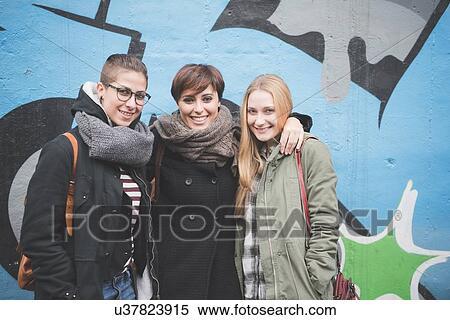 Three sisters by graffiti wall View Large Photo Image Stock Photography - Three sisters by graffiti wall. Fotosearch