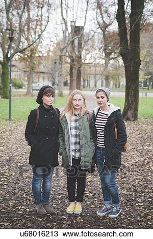 Three sisters posing in park View Large Photo Image Stock Image - Three sisters posing in park. Fotosearch