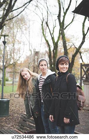 Stock Photograph - Three sisters posing in park. Fotosearch