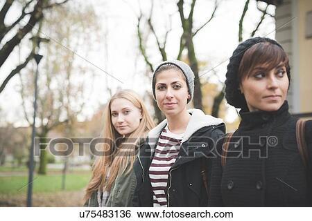 Stock Photograph - Three sisters posing in park. Fotosearch