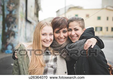 Three sisters posing on street View Large Photo Image Stock Image - Three sisters posing on street. Fotosearch