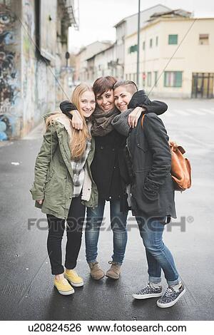 Stock Photograph - Three sisters posing on street. Fotosearch