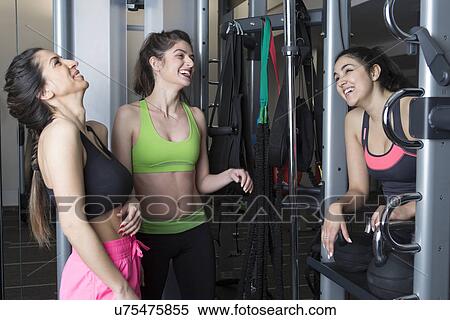 Three young women laughing and smiling in gym View Large Photo Image Stock Photography - Three young women laughing and smiling in gym. Fotosearch