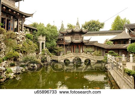 Stock Image - "Traditional Chinese garden with fish pool, stone bridge and pavilions, Hangzhou, China". Fotosearch