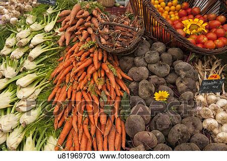 Stock Image - "Traditional French market stall with vegetables on display, Issigeac, France". Fotosearch
