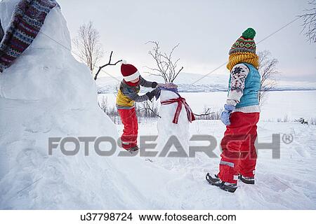 "Two boys making snowmen, Hemavan, Sweden" View Large Photo Image Picture - "Two boys making snowmen, Hemavan, Sweden". Fotosearch