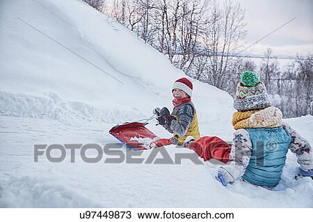 "Two brothers on toboggan on snow covered hill, Hemavan, Sweden" View Large Photo Image Stock Image - "Two brothers on toboggan on snow covered hill, Hemavan, Sweden". Fotosearch