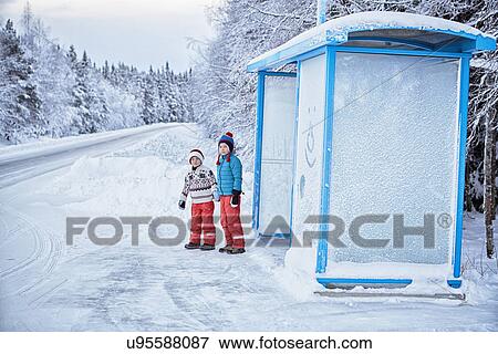 "Two brothers waiting at snow covered bus stop, Hemavan, Sweden" View Large Photo Image Stock Photo - "Two brothers waiting at snow covered bus stop, Hemavan, Sweden". Fotosearch