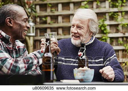 Stock Photography - Two senior men drinking beer. Fotosearch