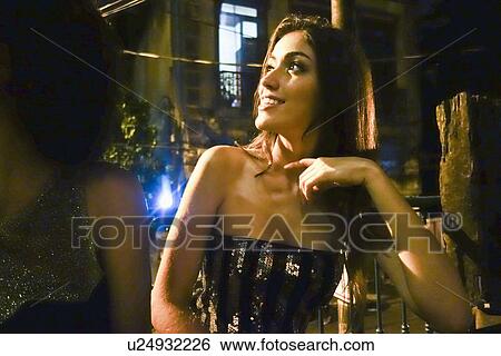 Stock Photograph - "Two young women sitting in bar, looking away". Fotosearch