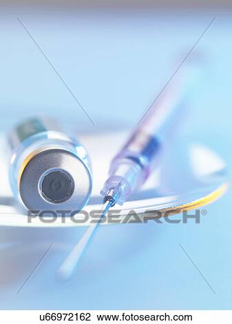 Vaccine and hypodermic syringe sitting on a glass dish View Large Photo Image Stock Image - Vaccine and hypodermic syringe sitting on a glass dish. Fotosearch