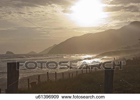 Stock Photo - "View of silhouetted beach at sunset, Rio De Janeiro, Brazil". Fotosearch