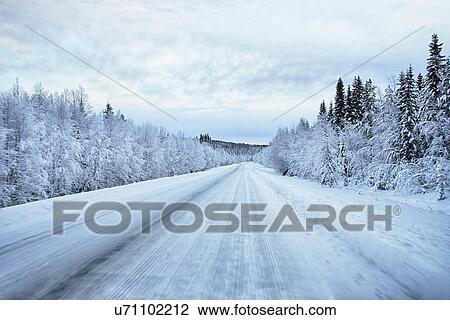 Stock Image - "View of snow covered highway, Hemavan, Sweden". Fotosearch