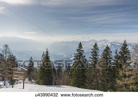 Stock Image - "View of wooden sign and distant misty mountains, Katrin, Bad Ischl, Austria". Fotosearch