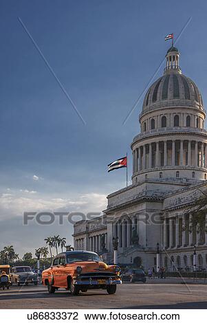 "Vintage car driving in front of Capitol Building, Havana, Cuba" View Large Photo Image Stock Image - "Vintage car driving in front of Capitol Building, Havana, Cuba". Fotosearch