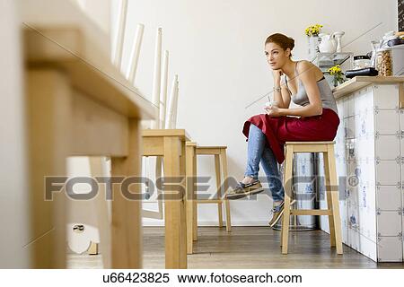 Waitress in cafe sitting on stool View Large Photo Image Stock Photography - Waitress in cafe sitting on stool. Fotosearch
