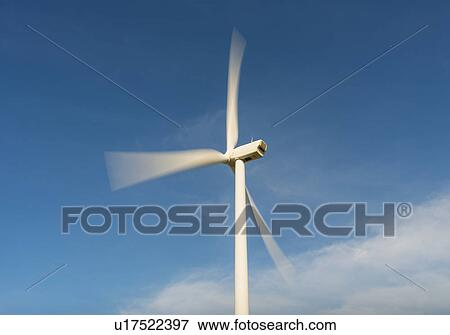 Stock Photo - "Wind turbine in motion against blue sky, Netherlands". Fotosearch