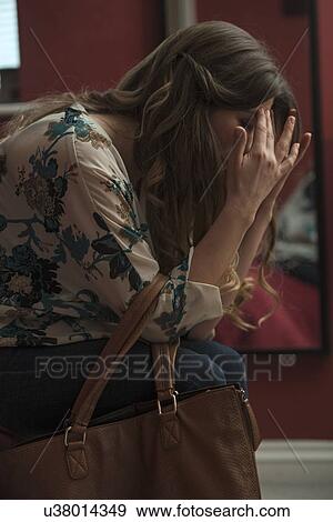 Woman holding head in hands View Large Photo Image Stock Photo - Woman holding head in hands. Fotosearch