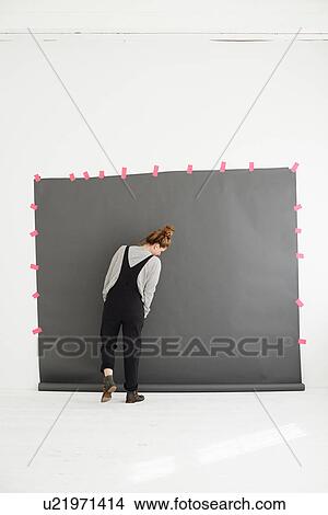 Picture - "Woman in front of photographers backdrop, rear view". Fotosearch