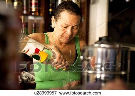 Woman serving liquor in bar View Large Photo Image Stock Photo - Woman serving liquor in bar. Fotosearch