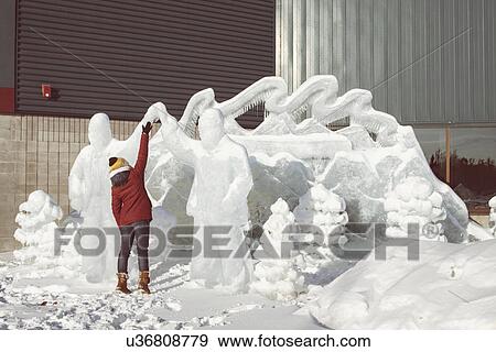 Stock Photo - Woman touching ice sculpture. Fotosearch