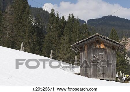 Stock Image - "Wooden hut on snow covered mountainside, Gosausee, Austria". Fotosearch