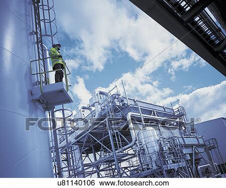 "Worker at gas fired power station, low angle view" View Large Photo Image Stock Photograph - "Worker at gas fired power station, low angle view". Fotosearch