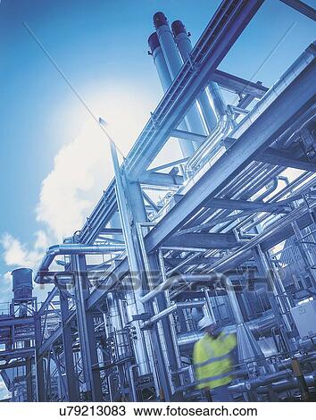 "Worker in gas fired power station, low angle view" View Large Photo Image Stock Image - "Worker in gas fired power station, low angle view". Fotosearch
