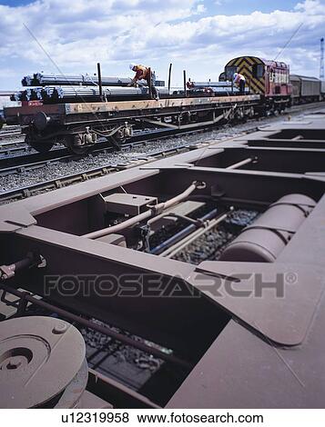 "Workers loading freight train with steel in port, Grimsby, England, United Kingdom" View Large Photo Image Stock Photo - "Workers loading freight train with steel in port, Grimsby, England, United Kingdom". Fotosearch
