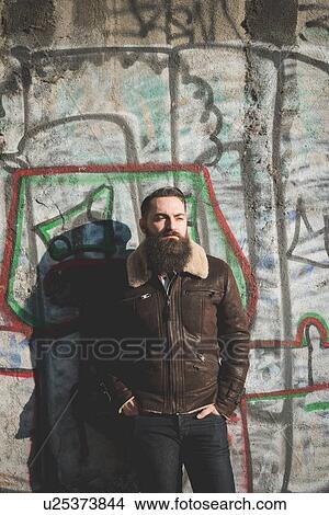 Young bearded man by graffiti wall View Large Photo Image Picture - Young bearded man by graffiti wall. Fotosearch