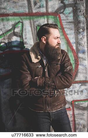 Young bearded man by graffiti wall View Large Photo Image Stock Image - Young bearded man by graffiti wall. Fotosearch