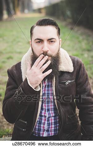 "Young bearded man in park, Milan, Italy" View Large Photo Image Stock Photograph - "Young bearded man in park, Milan, Italy". Fotosearch