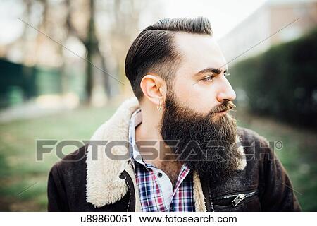 Young bearded man in park View Large Photo Image Stock Image - Young bearded man in park. Fotosearch