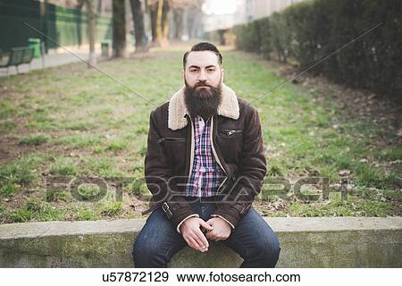 Young bearded man in park View Large Photo Image Stock Photo - Young bearded man in park. Fotosearch