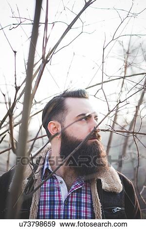 Young bearded man in park View Large Photo Image Stock Photo - Young bearded man in park. Fotosearch