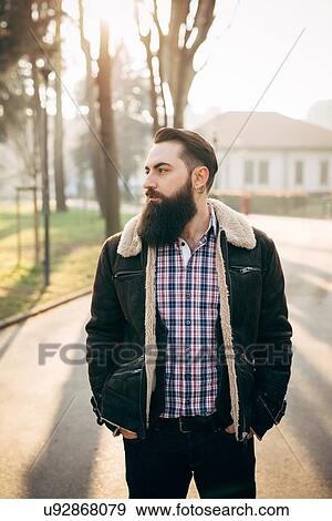 Stock Photo - Young bearded man in park. Fotosearch