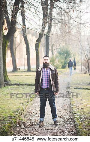 Young bearded man in park View Large Photo Image Stock Photography - Young bearded man in park. Fotosearch