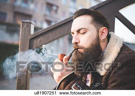 Young bearded man smoking pipe on steps View Large Photo Image Stock Image - Young bearded man smoking pipe on steps. Fotosearch