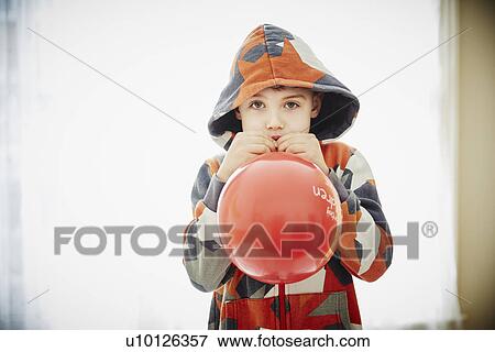 Young boy blowing red balloon View Large Photo Image Stock Photo - Young boy blowing red balloon. Fotosearch