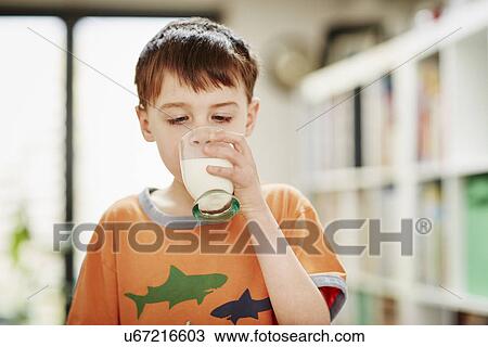 Stock Image - Young boy drinking glass of milk. Fotosearch
