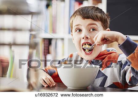 Young boy eating breakfast View Large Photo Image Stock Image - Young boy eating breakfast. Fotosearch